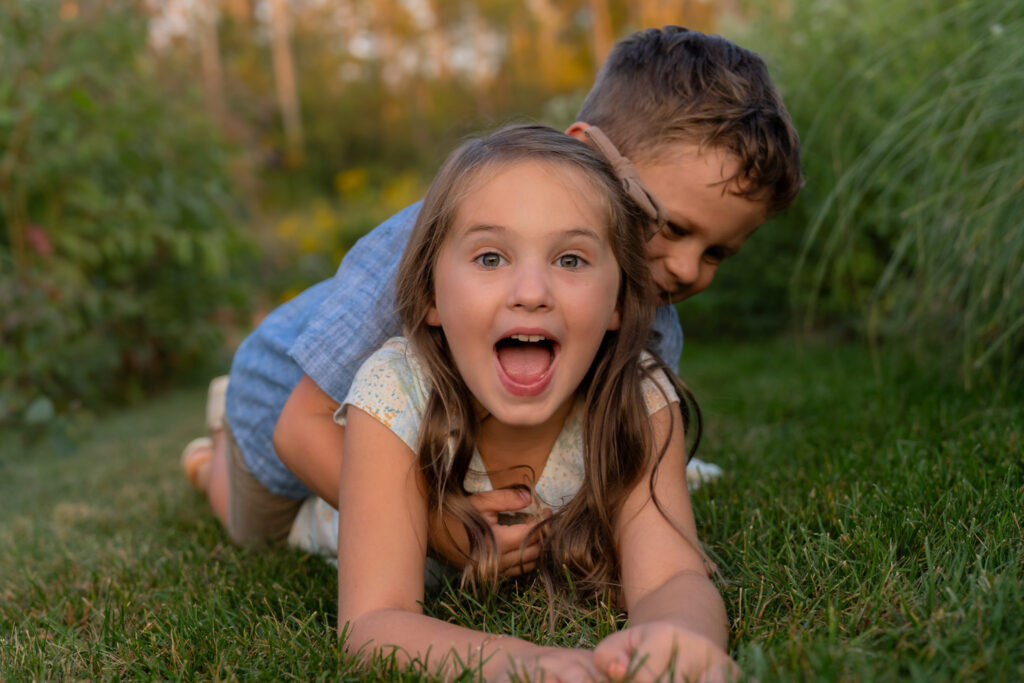 Kids being silly and playing around during a family photography session with MelMarie Photography in West Bend Wisconsin