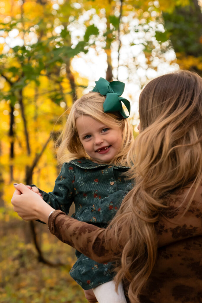 Fall family photos at Menomonee Park in Menomonee Falls Wisconsin with vibrant autumn colors