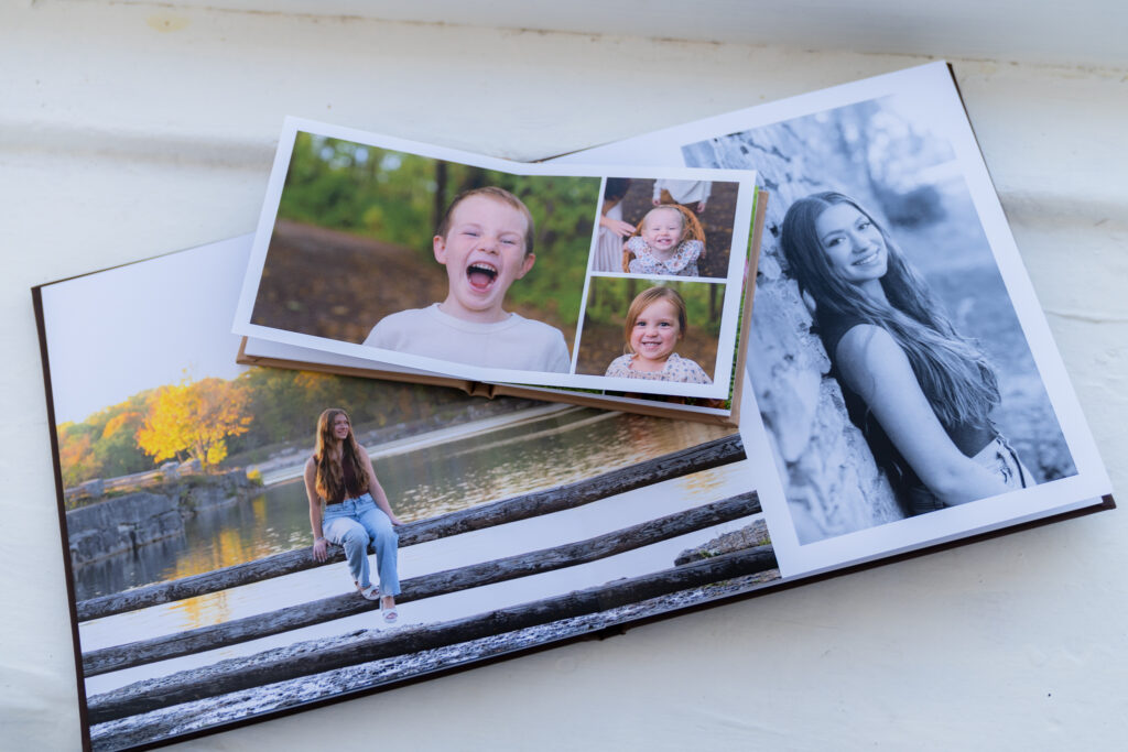 A professionally printed photography album in a white windowsill in West Bend