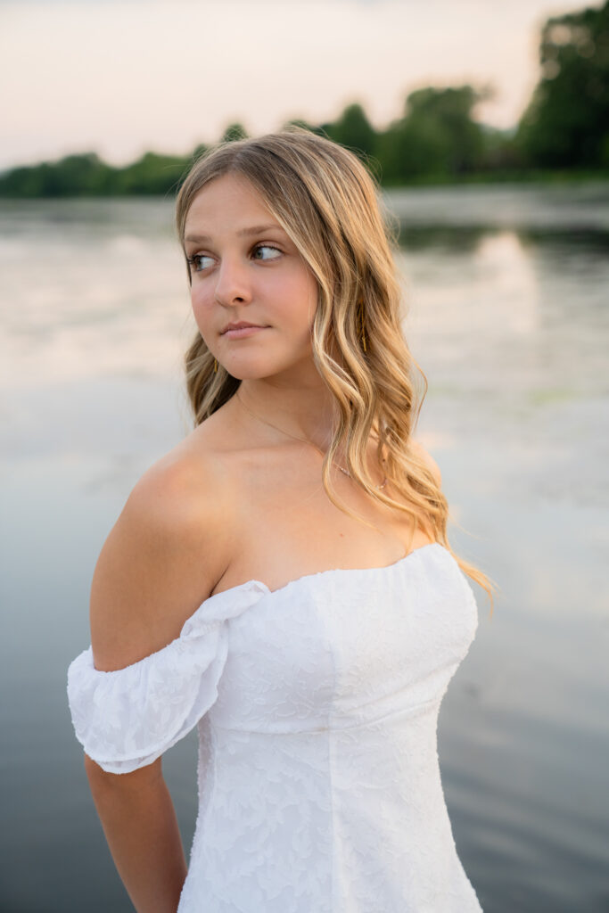 Senior girl standing in front of water