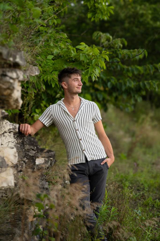 Man relaxing in a park next to Lannon stone at a quarry