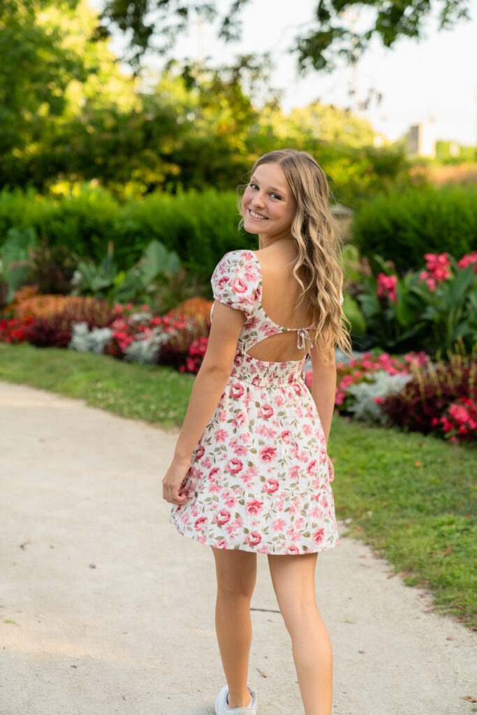 Girl walking through a park in a flower dress