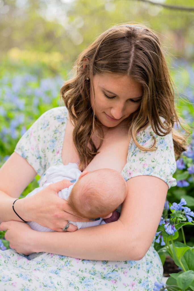 Mom breast feeding her newborn baby during a newborn photo session in Milwaukee Wisconsin