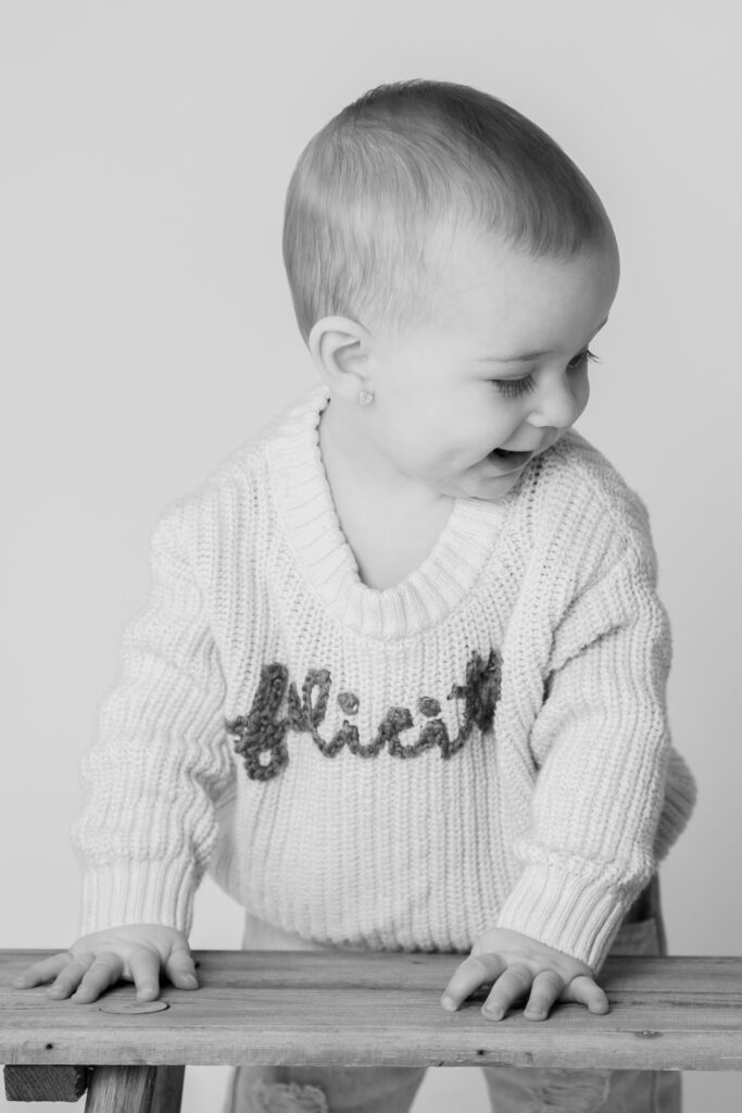 One year old girl smiling during a milestone photo session in Cedarburg Wisconsin