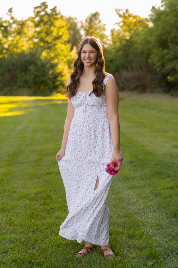 Candid moment of senior twirling dress and laughing during a senior photography experience