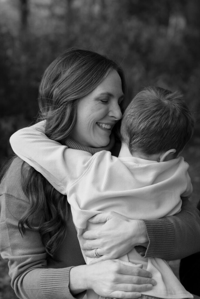 Mother hugging her son and smiling at him in Menomonee Falls Wisconsin