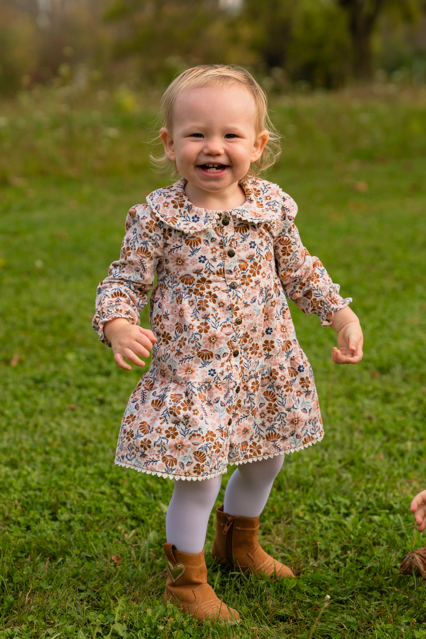 Toddler giggling and laughing at the photographer during a family photo shoot in Sussex wisconsin
