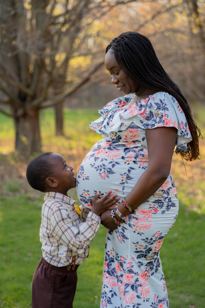 Little boy kissing his mamas belly during maternity session in milwaukee wisconsin