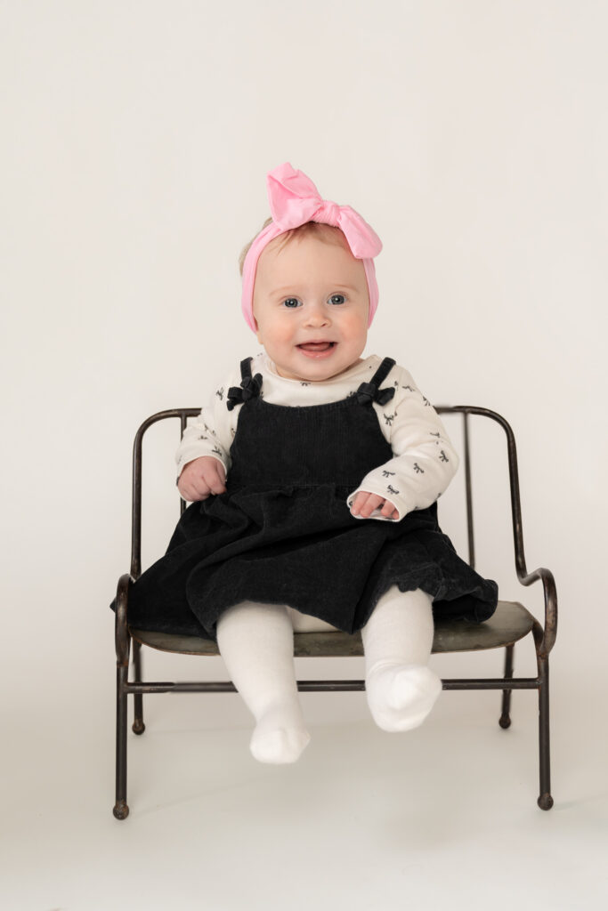 little girl smiling at photographer during milestone session in cedarburg wisconsin