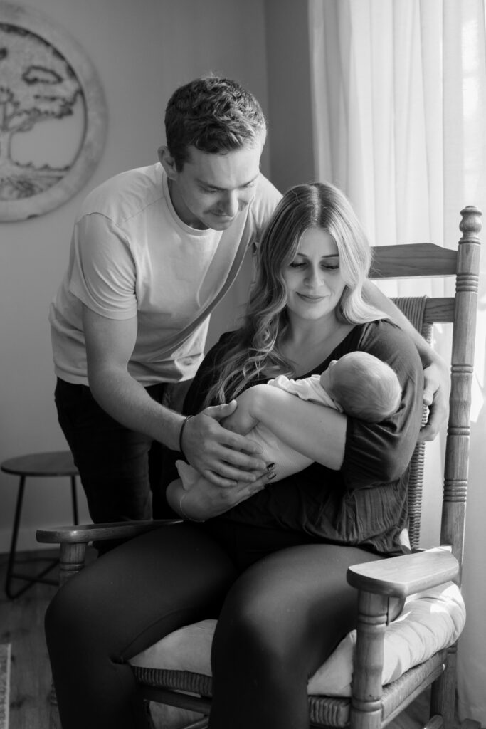 Mother and father holding their newborn baby in Menomonee falls wisconsin newborn photography session