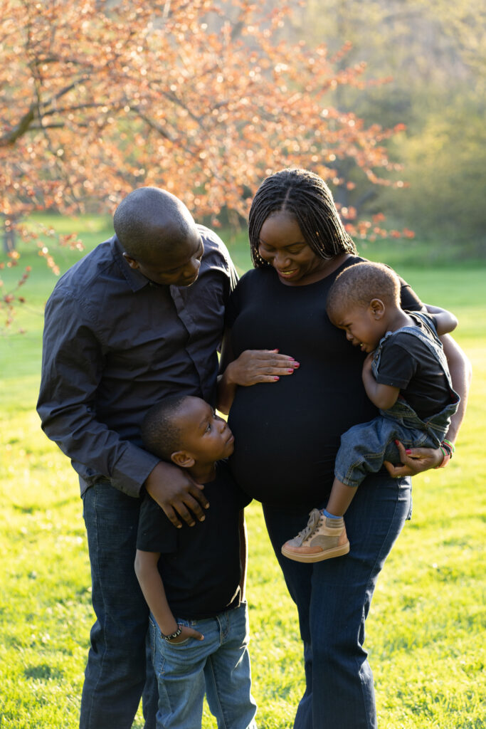 Family of four candidly smiling at one another in milwaukee wisconsin