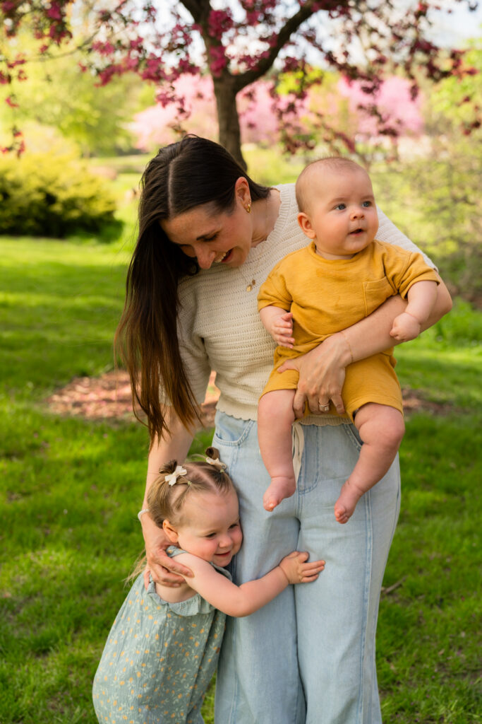 Mom holding her son while hugging her daughter during a spring family photo session in Waukesha, Wisconsin