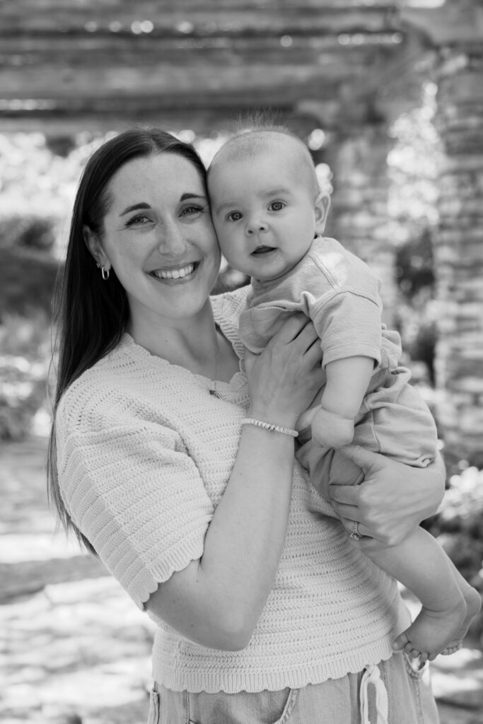 Mother holding her baby boy cheek to cheek and smiling at the camera in Waukesha, wisconsin