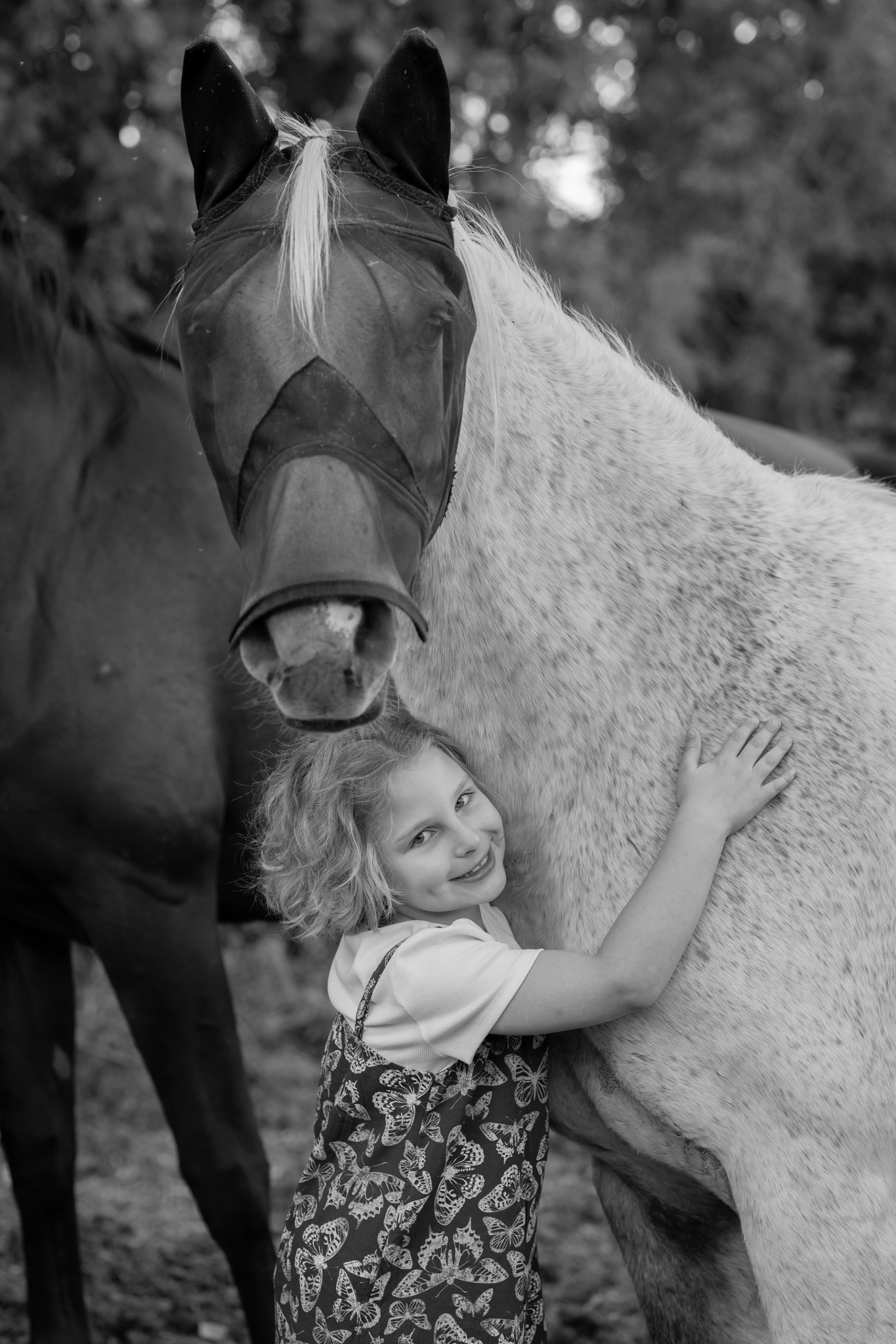 Young girl holding hugging her horse during family photography session in West Bend, Wisconsin