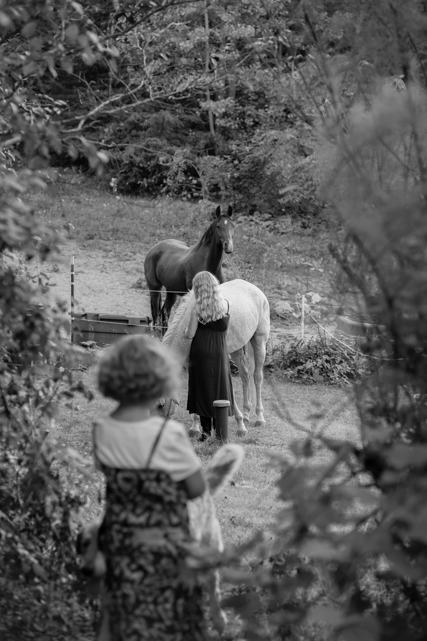Candid moment of two girls interacting with their horses in West Bend, Wisconsin