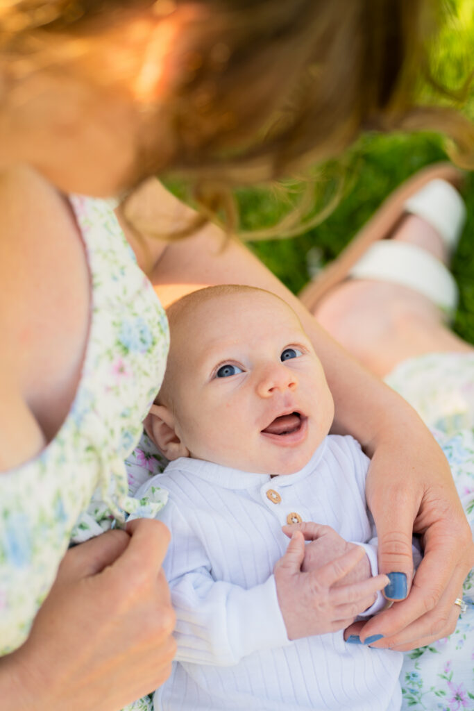 newborn baby smiling at his mother during newborn photography session in milwaukee wisconsin