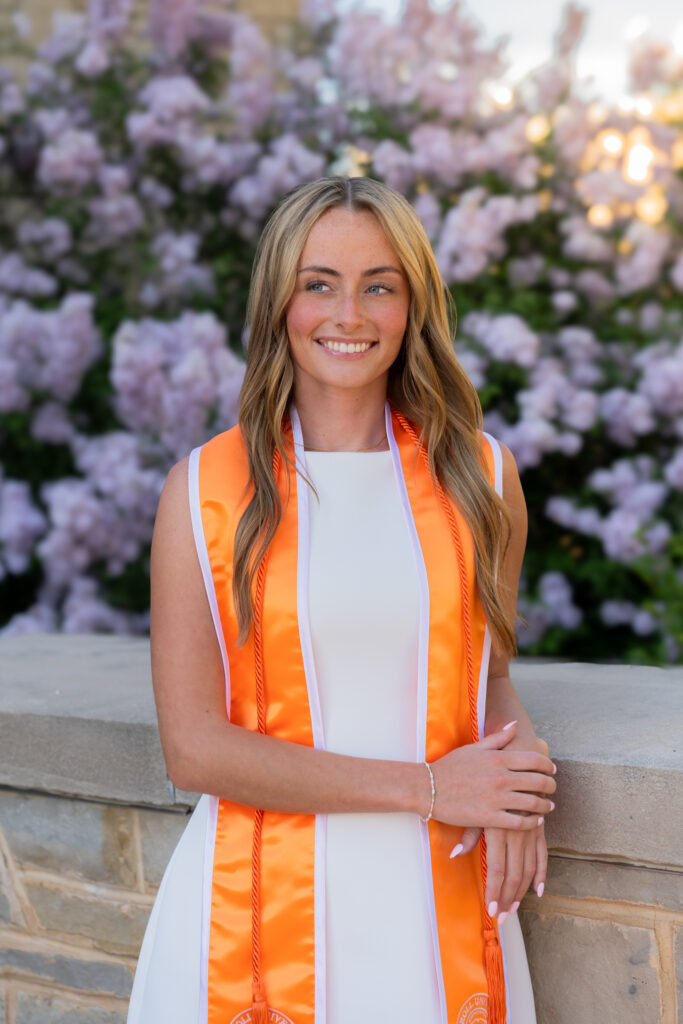 Senior portrait session at Carroll University near flowers and buildings