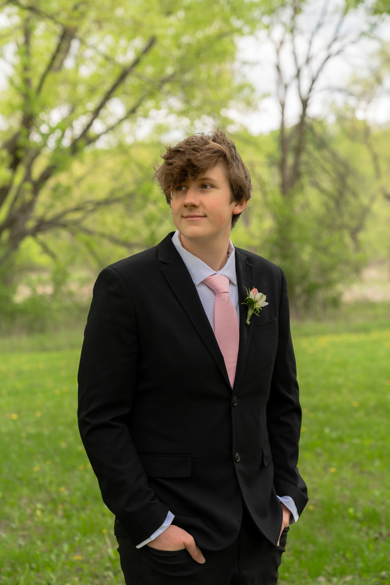 High school boy posing for prom photos at Kettle Moraine Pike Lake Unit in Hartford Wisconsin
