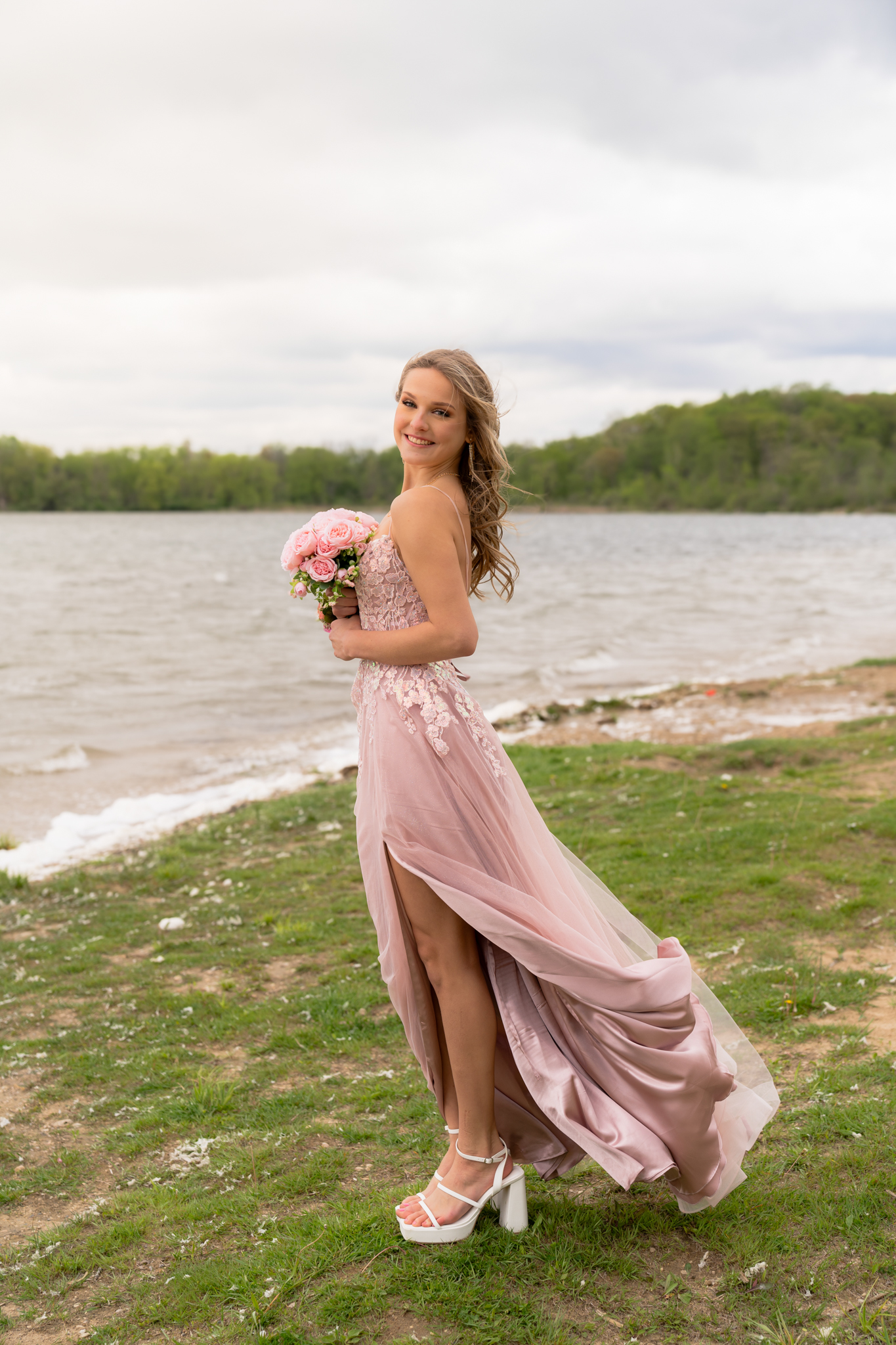Girl posing in her prom dress while holding her bouquet in Hartford, Wisconsin on Pike Lake